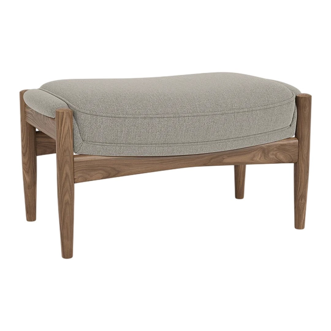 Light gray upholstered ottoman with a smooth, curved top and natural wood legs, showcasing a minimalist design.