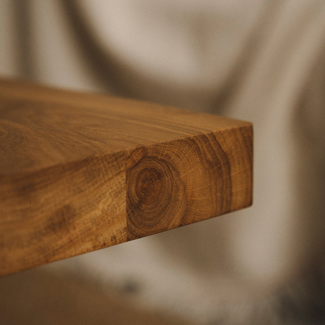 Close-up of a rich brown wooden tabletop, featuring natural grain patterns and smooth edges.