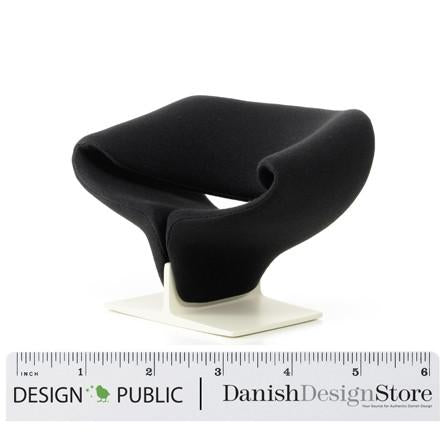 Sleek black chair with modern curves, featuring a minimalist white base and no visible patterns.