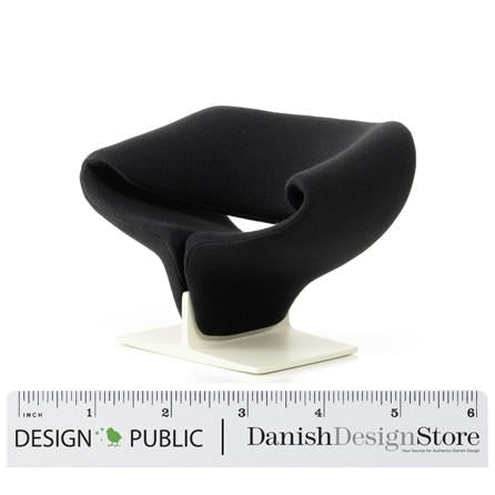 Sleek black chair with modern curves, featuring a minimalist white base and no visible patterns.