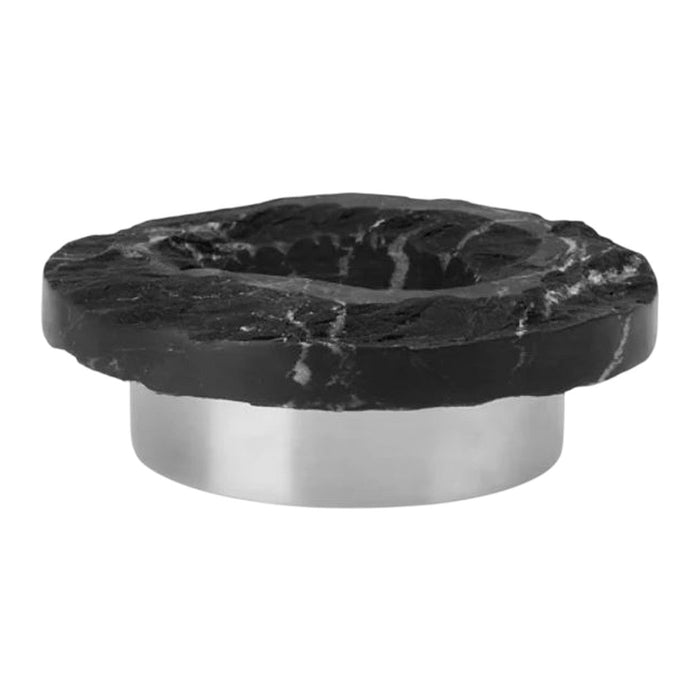 Black stone serving bowl with a natural, rough edge and shiny metallic base, showcasing striking marble patterns.