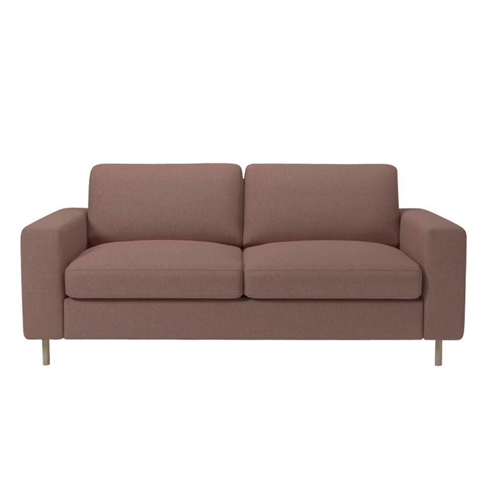 Modern two-seater sofa in a soft mauve fabric with simple, clean lines and minimalistic design.