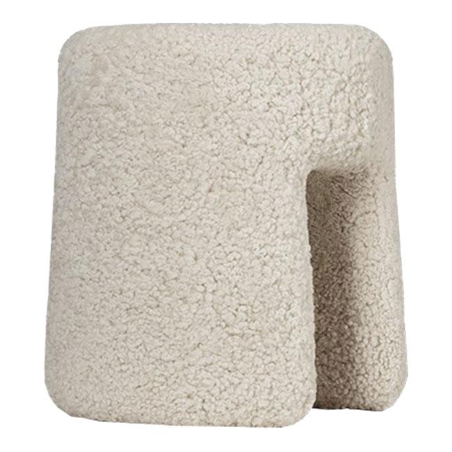 Beige textured stool with a fuzzy, organic shape and soft, cozy surface pattern, perfect for modern decor.