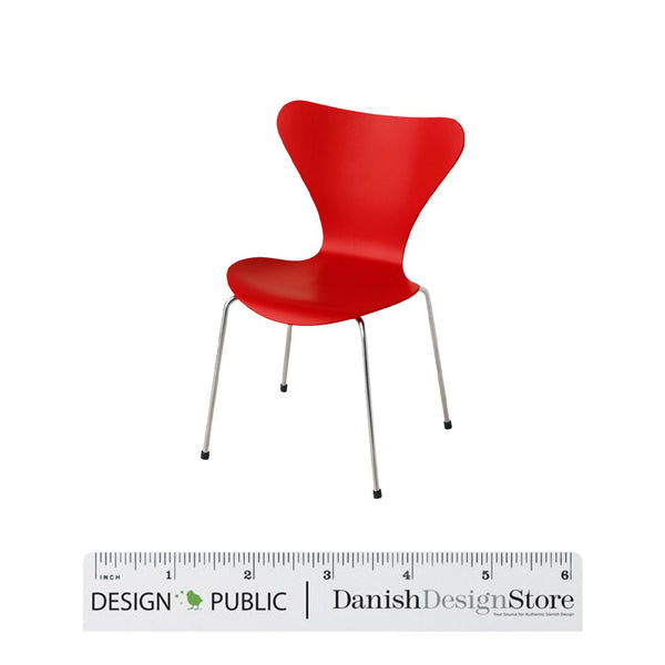 Red chair with a modern, smooth design and silver legs, perfect for adding a pop of color to any space.