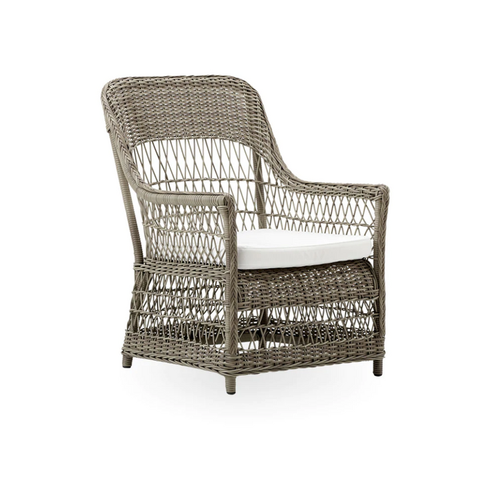Gray woven rattan chair with a white cushion, featuring an open-strand pattern for a modern, airy look.