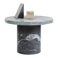 Circular gray marble side table with unique swirling patterns and geometric decor pieces on top.