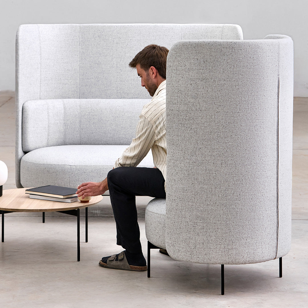 Light gray fabric sofa with a textured pattern and curved design, featuring black metal legs for modern appeal.