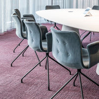 Gray upholstered chairs on a rich burgundy carpet in a modern conference setting. Elegant and stylish design.