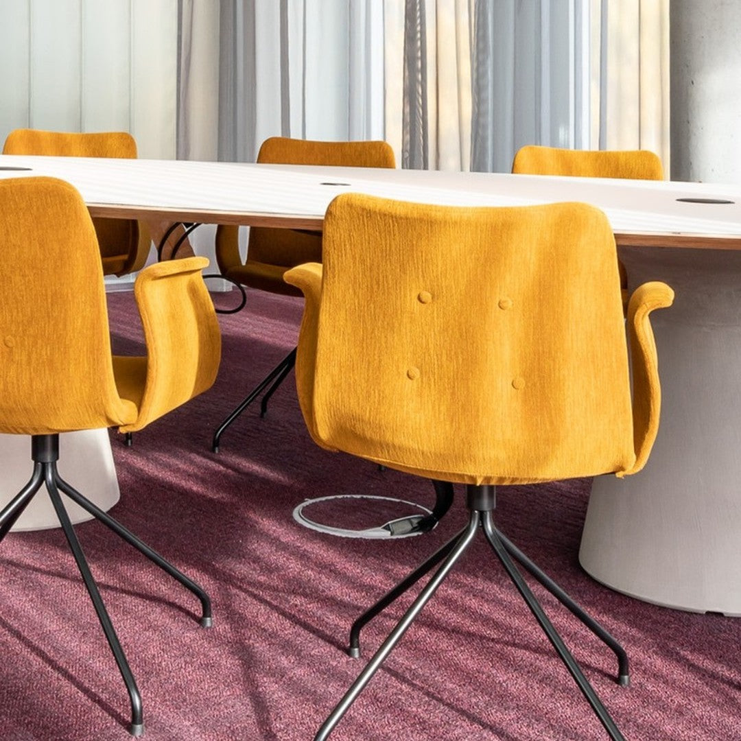 "Vibrant mustard yellow chairs with a soft texture on a rich purple carpet, surrounded by a modern meeting table."