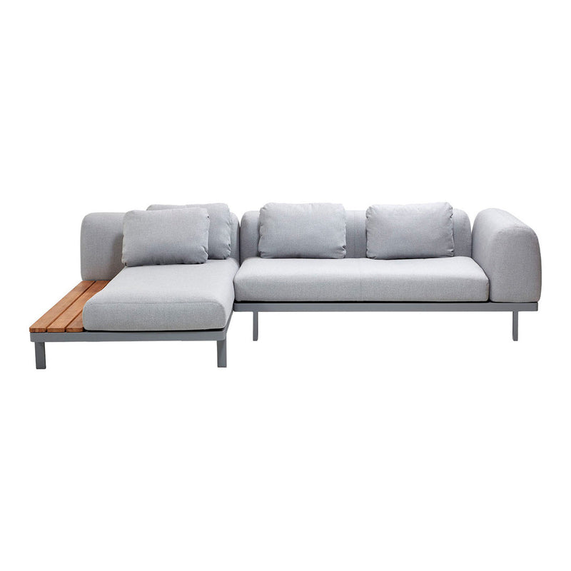 Light gray sectional sofa with plush cushions and a natural wood accent, featuring a modern minimalist design.
