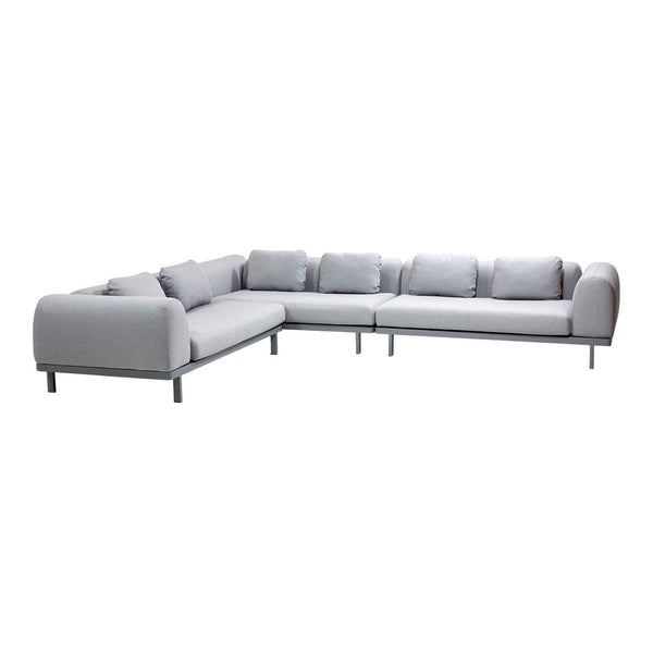 Modern grey sectional sofa with minimalistic design and plush cushions, featuring a sleek metal frame.