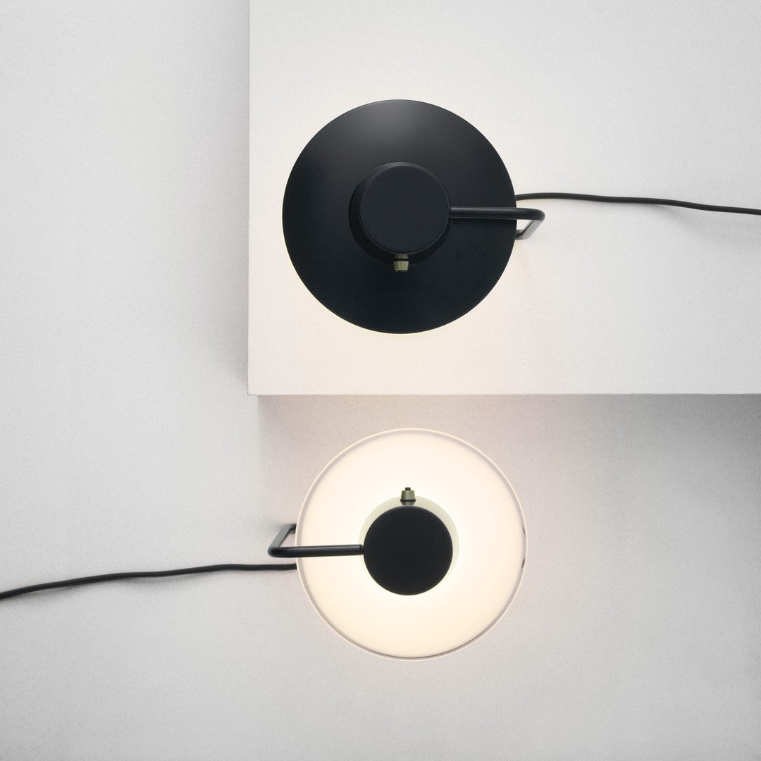 Two modern wall lamps featuring a black round base and a white circular shade for a stylish contrast.