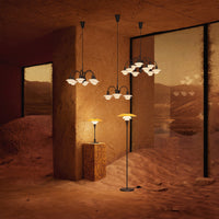 Modern lighting featuring warm tones, black accents, and elegant floral glass patterns in a desert-themed setting.