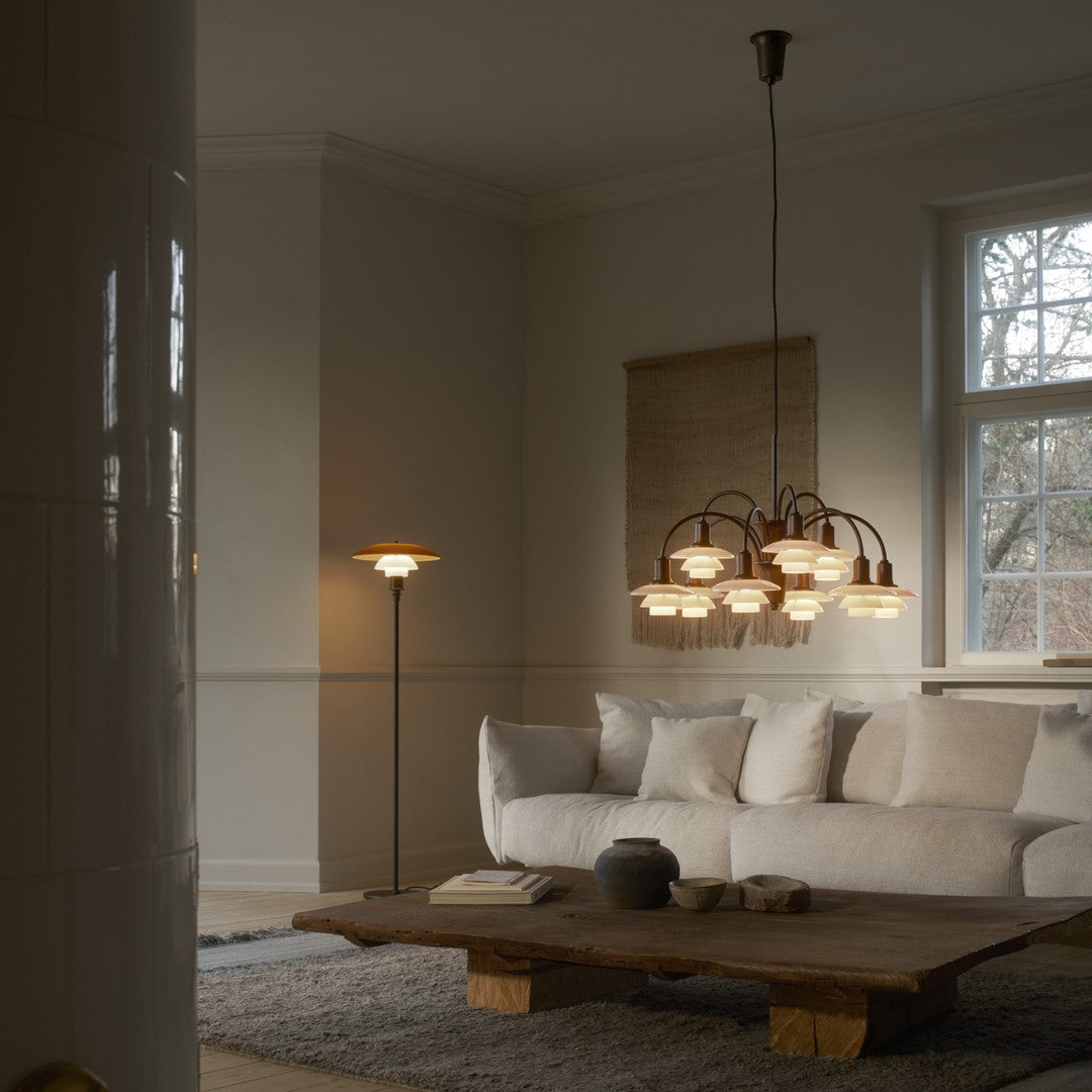Elegant beige and white living room featuring a rustic wooden coffee table and a stylish multi-bulb hanging light fixture.