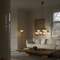 Elegant beige and white living room featuring a rustic wooden coffee table and a stylish multi-bulb hanging light fixture.