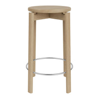 Natural wood bar stool with a light oak finish and sleek chrome footrest, showcasing a minimalist design.