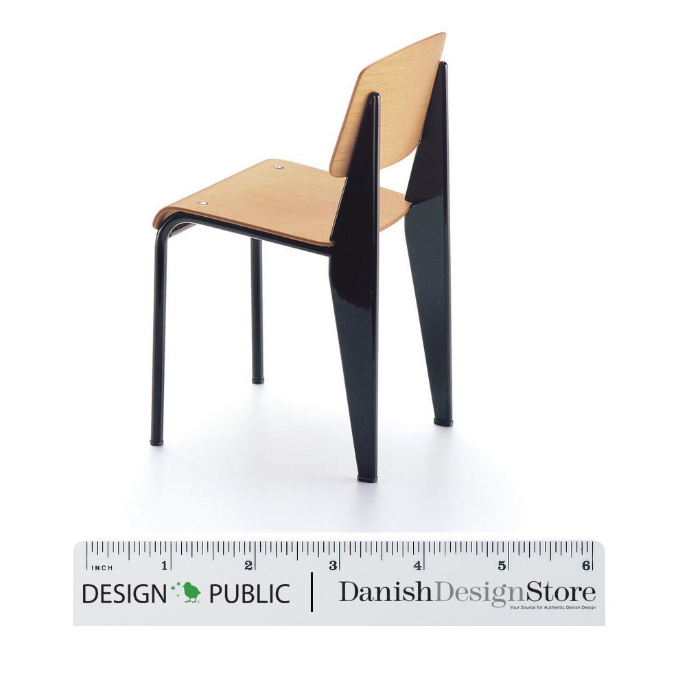 Minimalist chair with a natural wood seat and sleek black metal legs, showcasing a modern geometric design.
