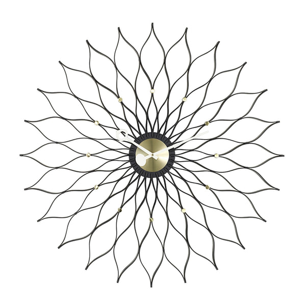 Black metal wall clock featuring a floral pattern with gold accents, ideal for modern decor.