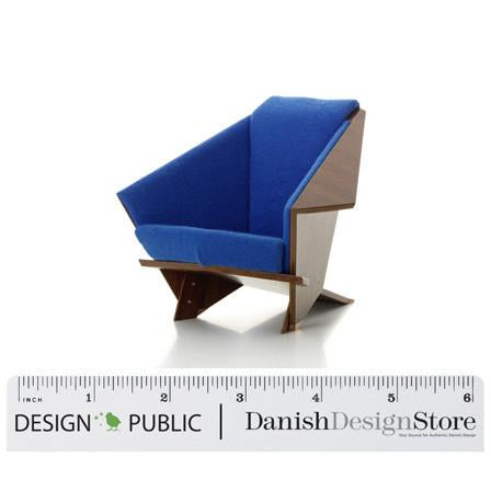 Blue upholstered chair with a modern geometric pattern and contrasting wooden accents.