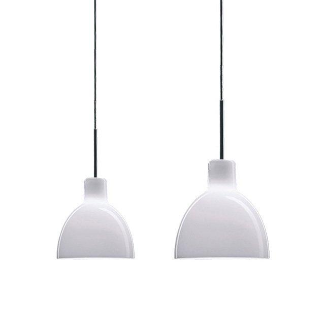 White pendant lamps with a sleek, modern design and smooth, glossy finishes hanging from black cables.