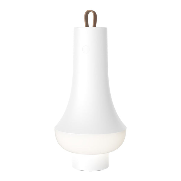 White bell-shaped lamp with a sleek design and a brown leather handle. Soft glow at the base enhances its minimalist look.