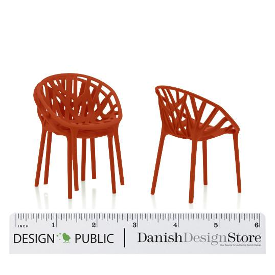 Set of two modern chairs featuring a vibrant orange color and a unique, woven pattern design.