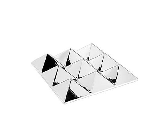"Shiny silver plate with geometric pyramid patterns reflecting light."