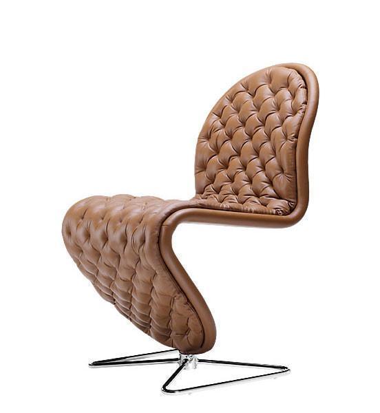 Brown quilted leather chair with a sleek chrome base and unique curved design, adding elegance to any space.