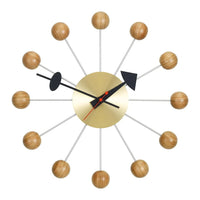 Mid-century modern wall clock with gold, black, and natural wood accents, featuring a radial design and sleek lines.