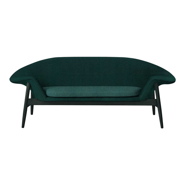 Teal upholstered sofa with a sleek, curved design and dark wood legs, showcasing a modern and stylish aesthetic.