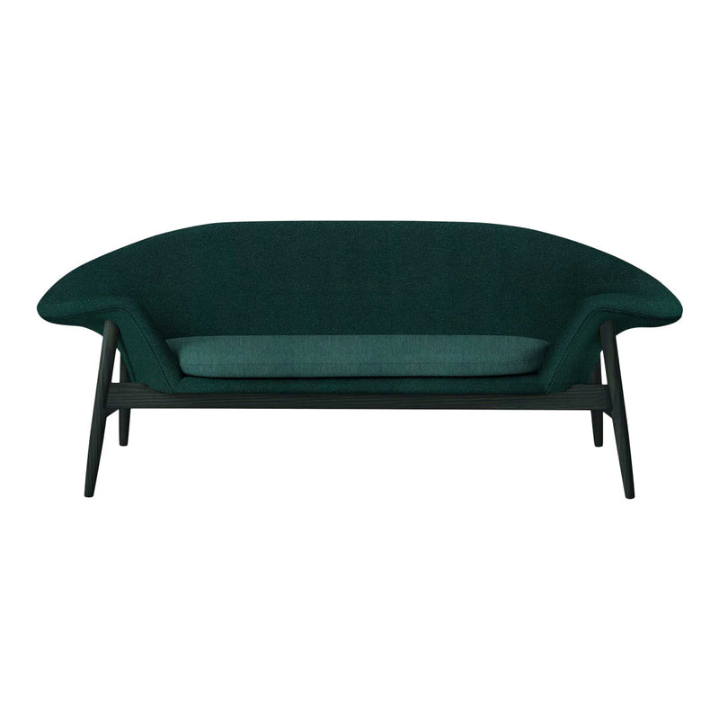 Teal upholstered sofa with a sleek, curved design and dark wood legs, showcasing a modern and stylish aesthetic.