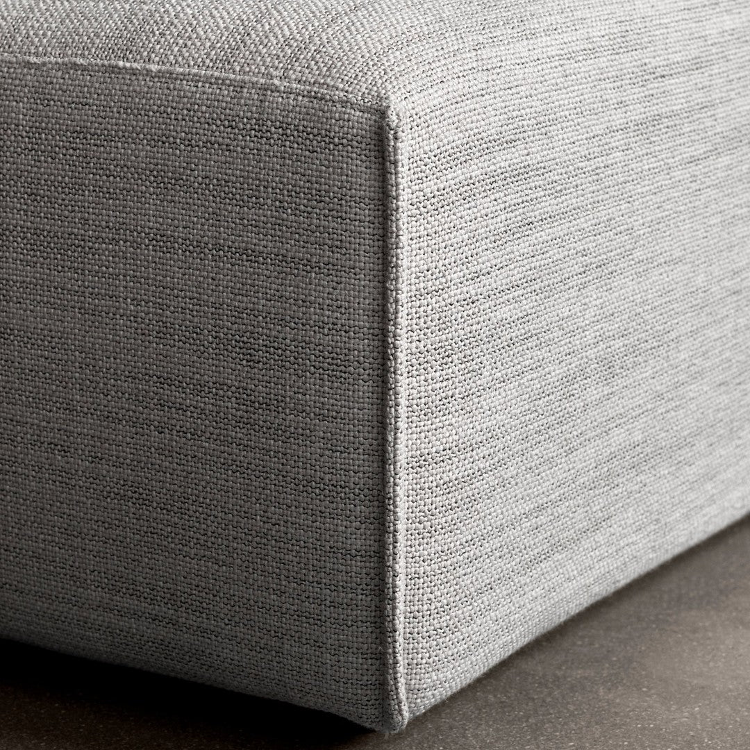 Gray textured fabric corner, showcasing a subtle woven pattern and sleek design. Perfect for modern decor.