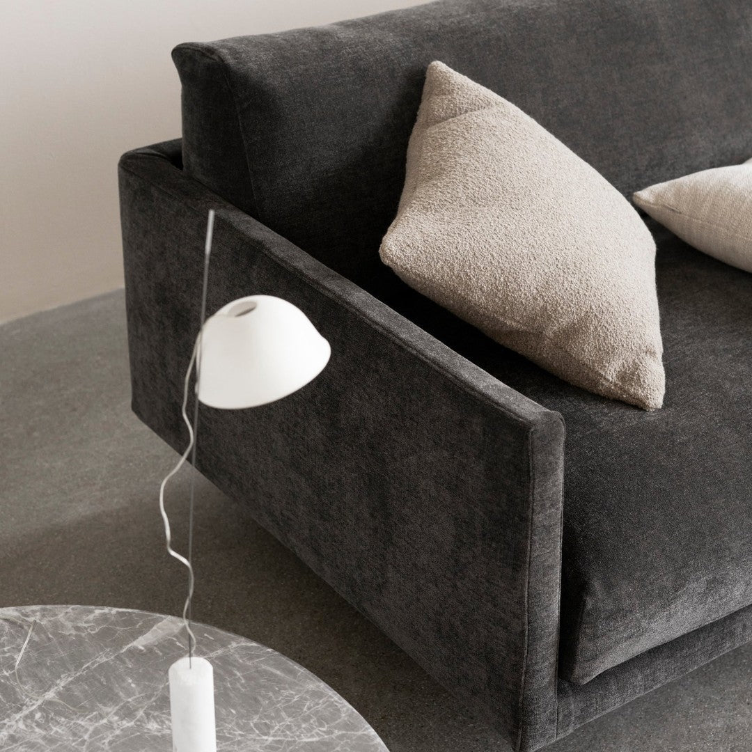 Gray upholstered sofa with neutral beige cushions and a sleek marble coffee table, featuring modern minimalist design.