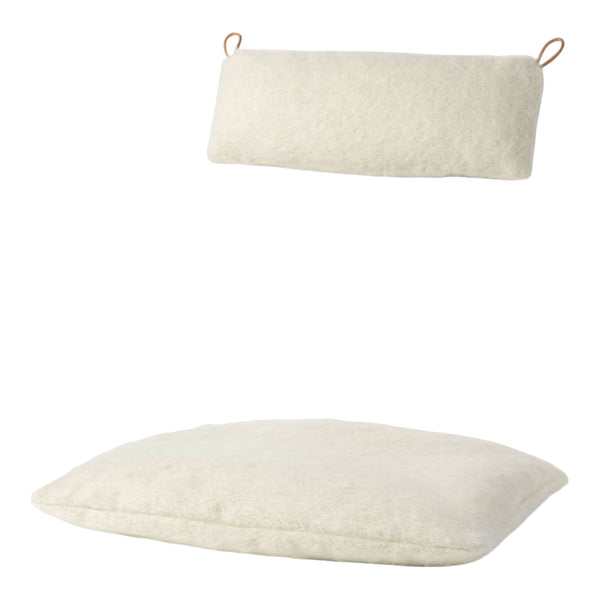 Cream-colored throw pillows with a soft, textured pattern, featuring a rectangular and square shape.