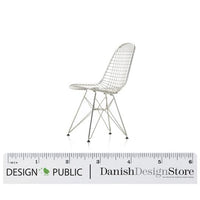 White wire mesh chair with a sleek modern design, featuring an intricate grid pattern and black tapered legs.